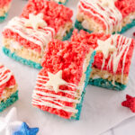 4th of july rice krispie treats on a piece of crinkled wax paper with the recipe ingredients in the background