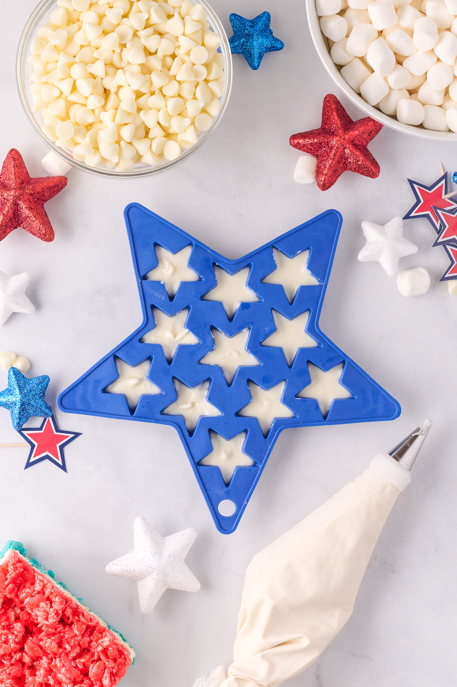 A blue star mold filled with melted white chocolate